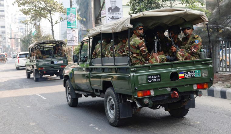 Members of Bangladesh Army patrol on the road in Dhaka
